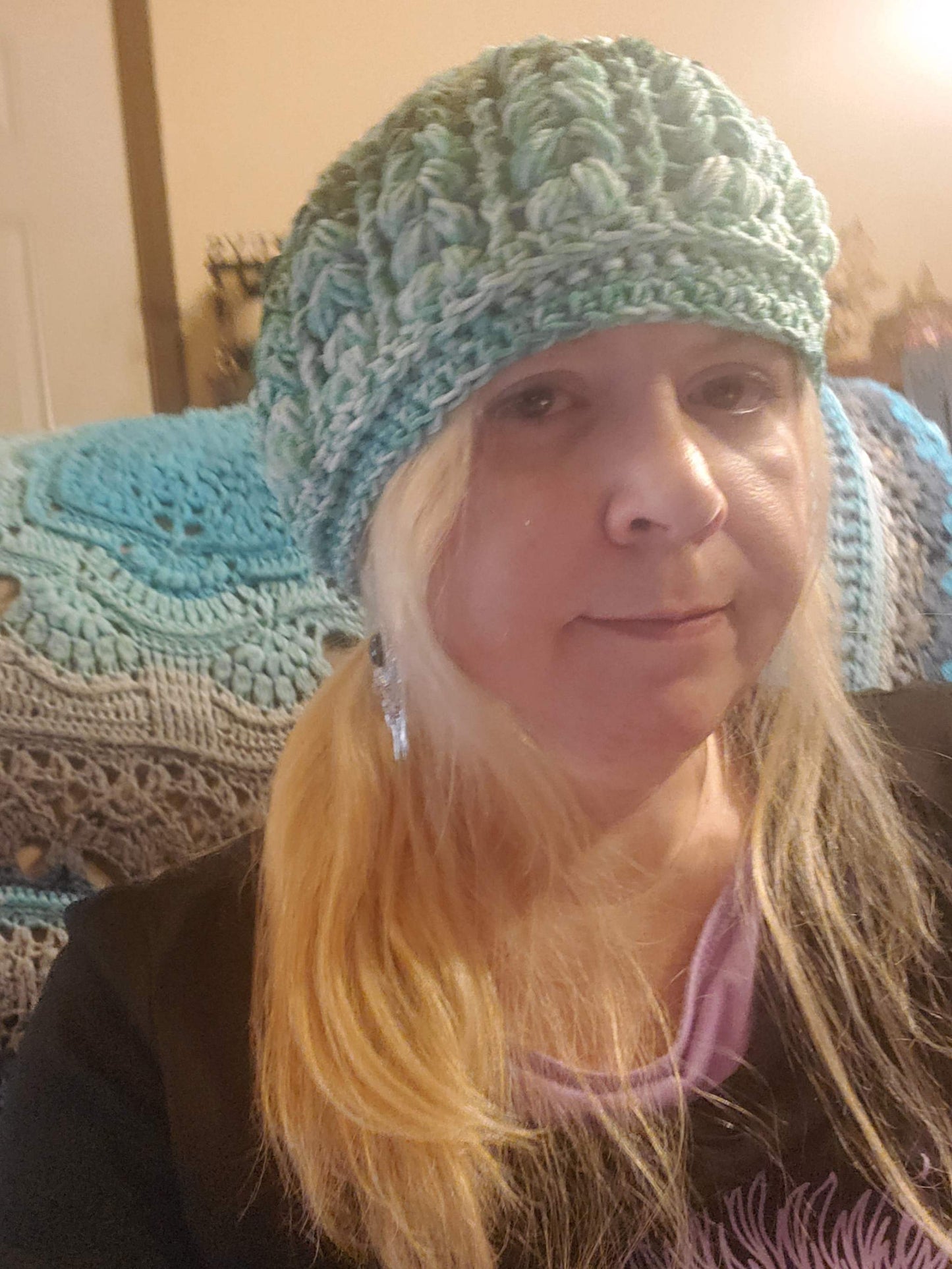 Crocheted Green Ombre Beanie Hat worn by a person, showcasing its stylish and elegant design.