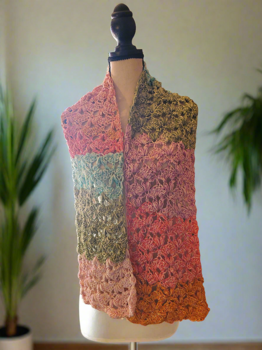 Beautiful handmade crocheted colorful fancy sweetheart scarf on display.
