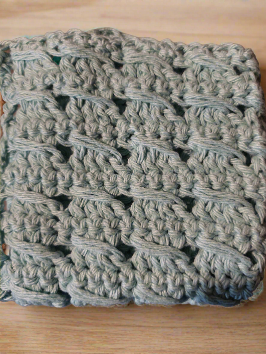 Handmade textured aqua dishcloths set of 4 on wooden surface.