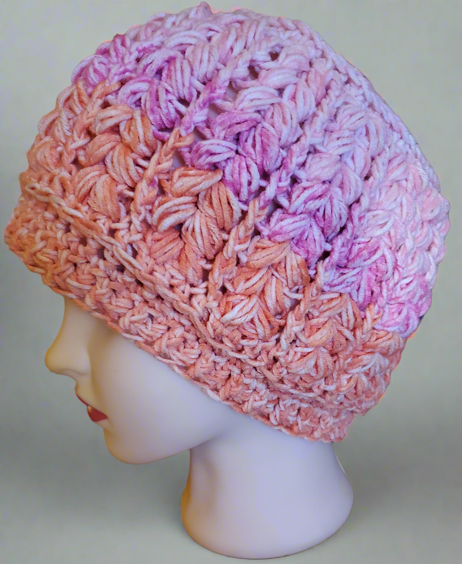 Women's crocheted pink and orange hat, fashionable and elegant, ideal for any occasion.