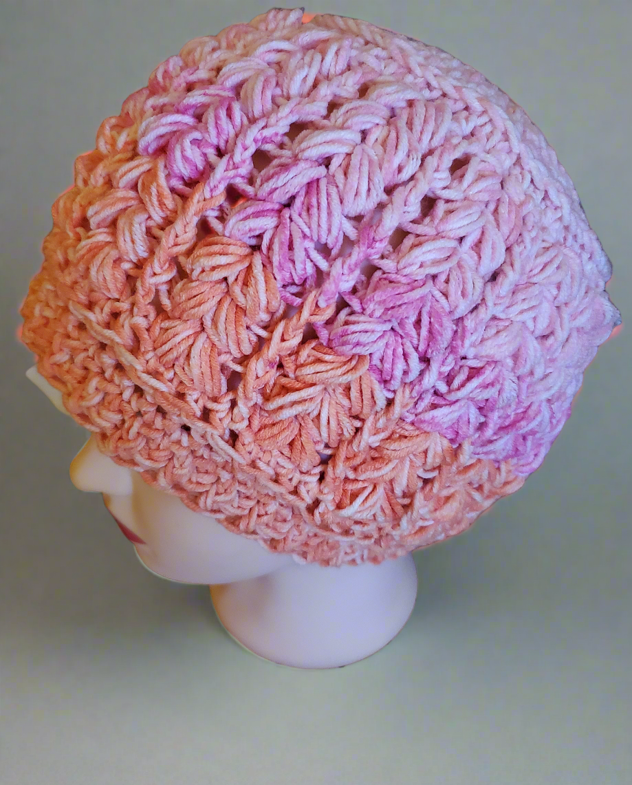 Crocheted pink and orange hat, soft and elegant design, ideal for any occasion.