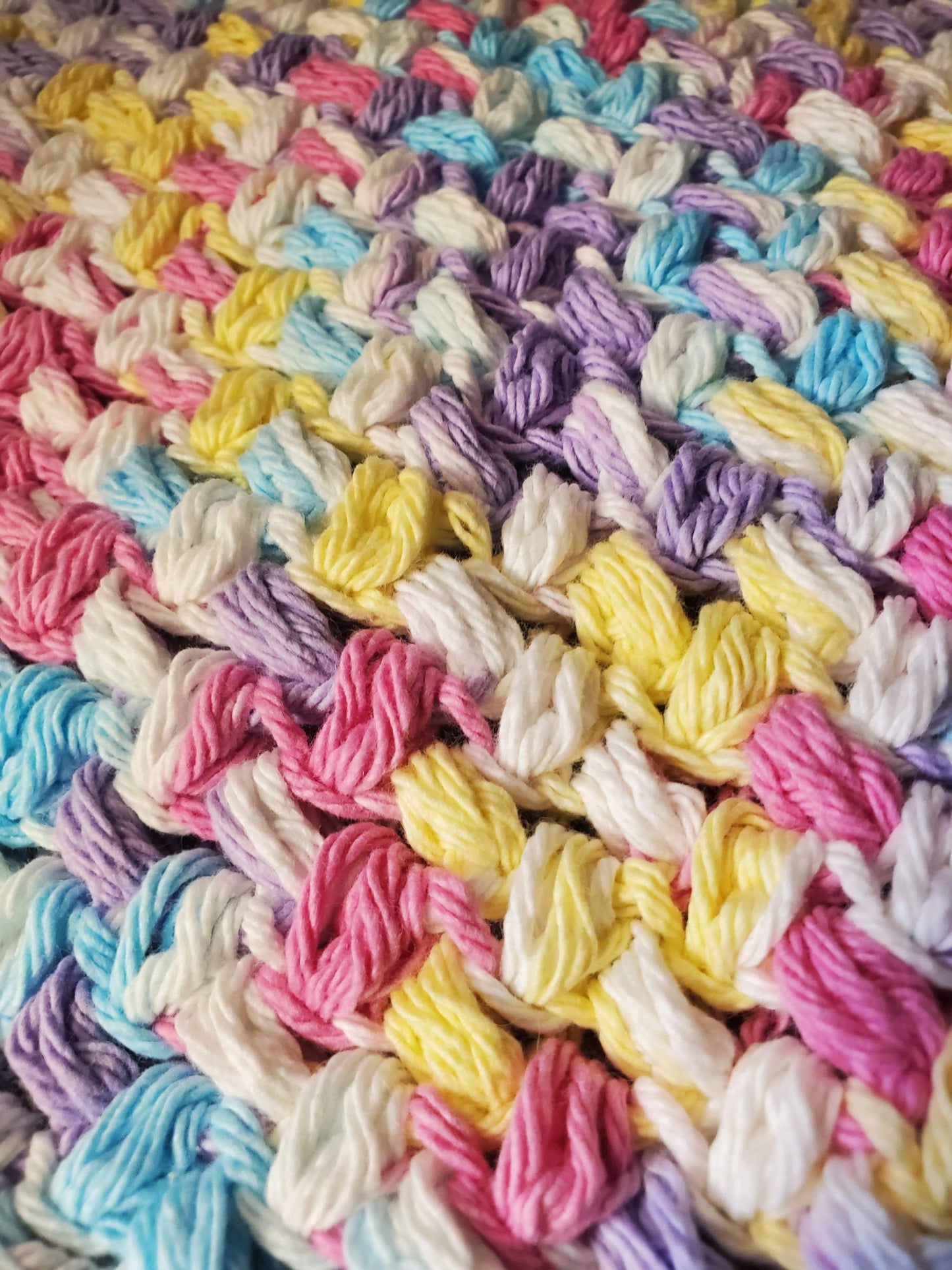 Crocheted rainbow dishcloths set of 4 in cotton, ideal for household cleaning.