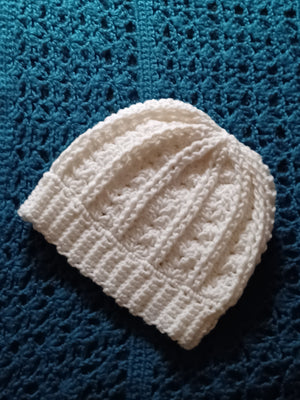 Handmade white crocheted beanie hat for men or women in simple style.