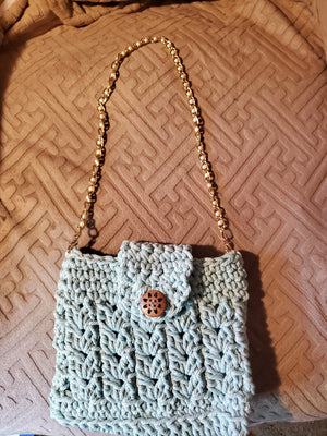 Super cute aqua handmade crocheted purse with golden pearl strap.