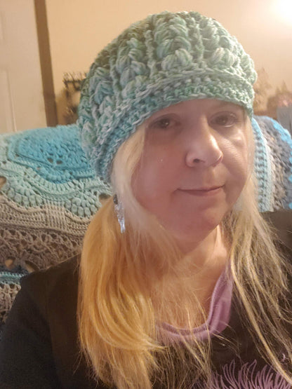 Crocheted Green Ombre Beanie Hat worn by a person, showcasing its stylish and elegant design.