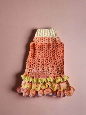 Fancy crocheted ruffled dress for pets with elegant design and shell stitching, perfect for special occasions.