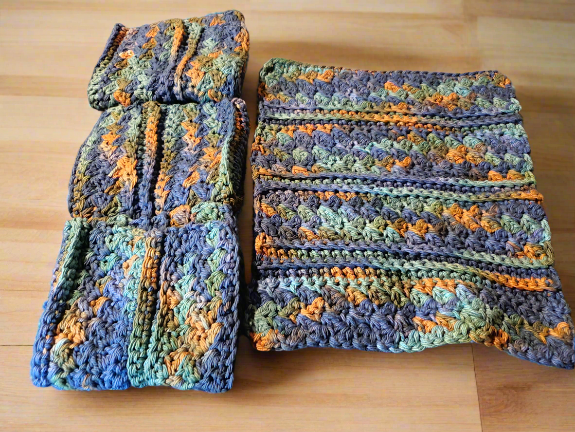 Set of 4 variegated dishcloths in dark blue, green, and brown for kitchen use.