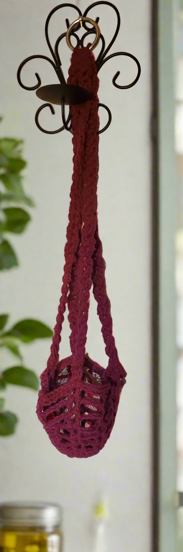 Red plant hanger for small to medium potted plants, vibrant decor accessory.