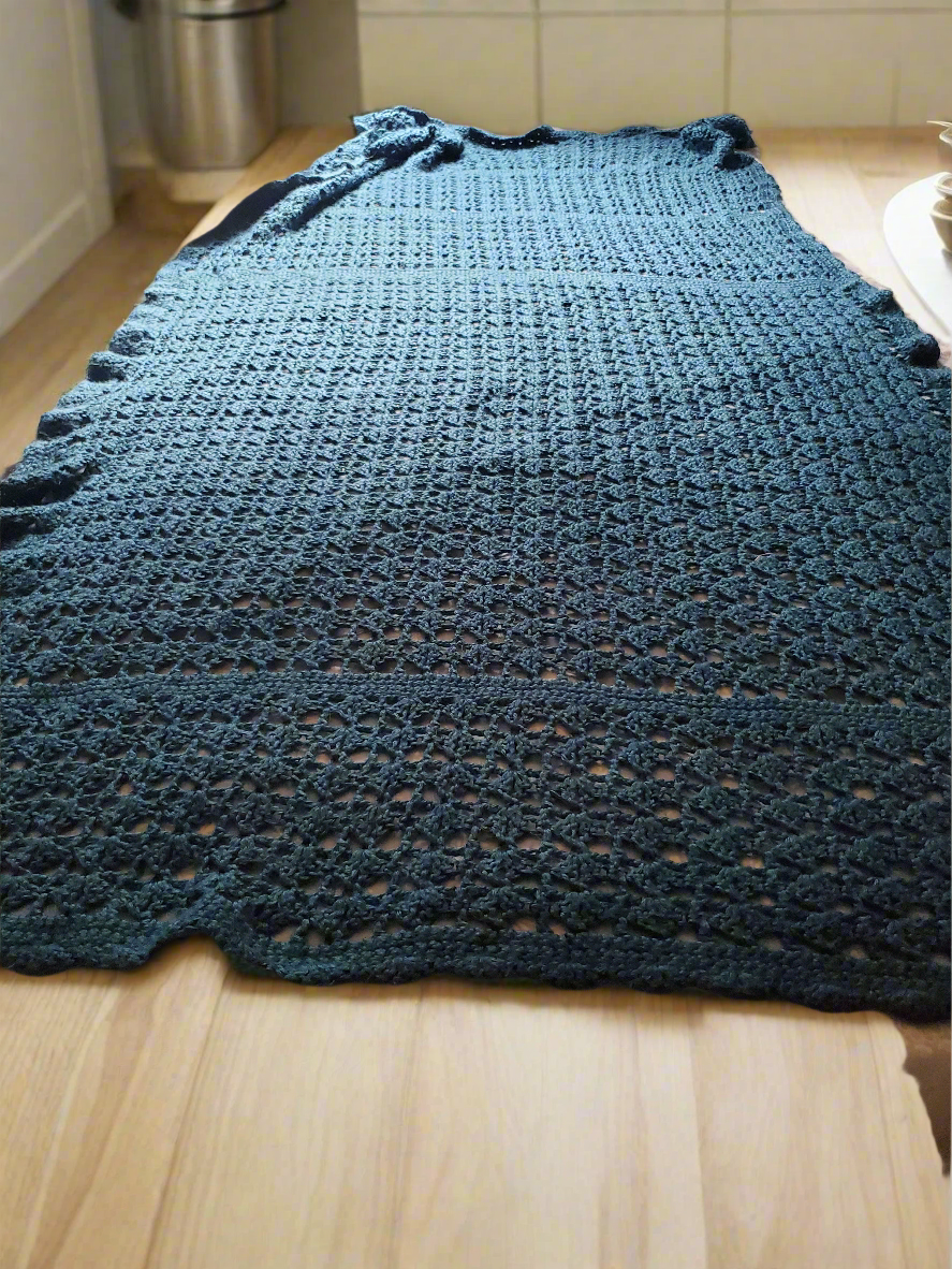 Beautiful teal Afghan soft lightweight handmade crocheted blanket on display