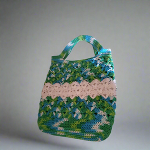 Handmade cotton variegated green blue and white crocheted market bag.