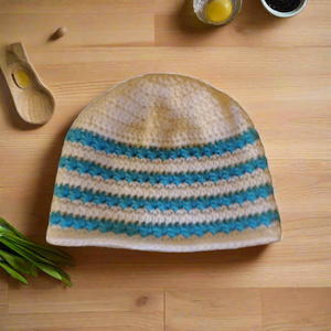 Blue and white handmade star stitch beanie on wooden surface.