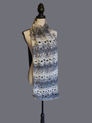 Gray and white handmade crocheted scarf on mannequin.