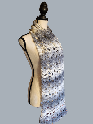 Gray and white handmade crocheted scarf, intricately designed, 65 inches long.