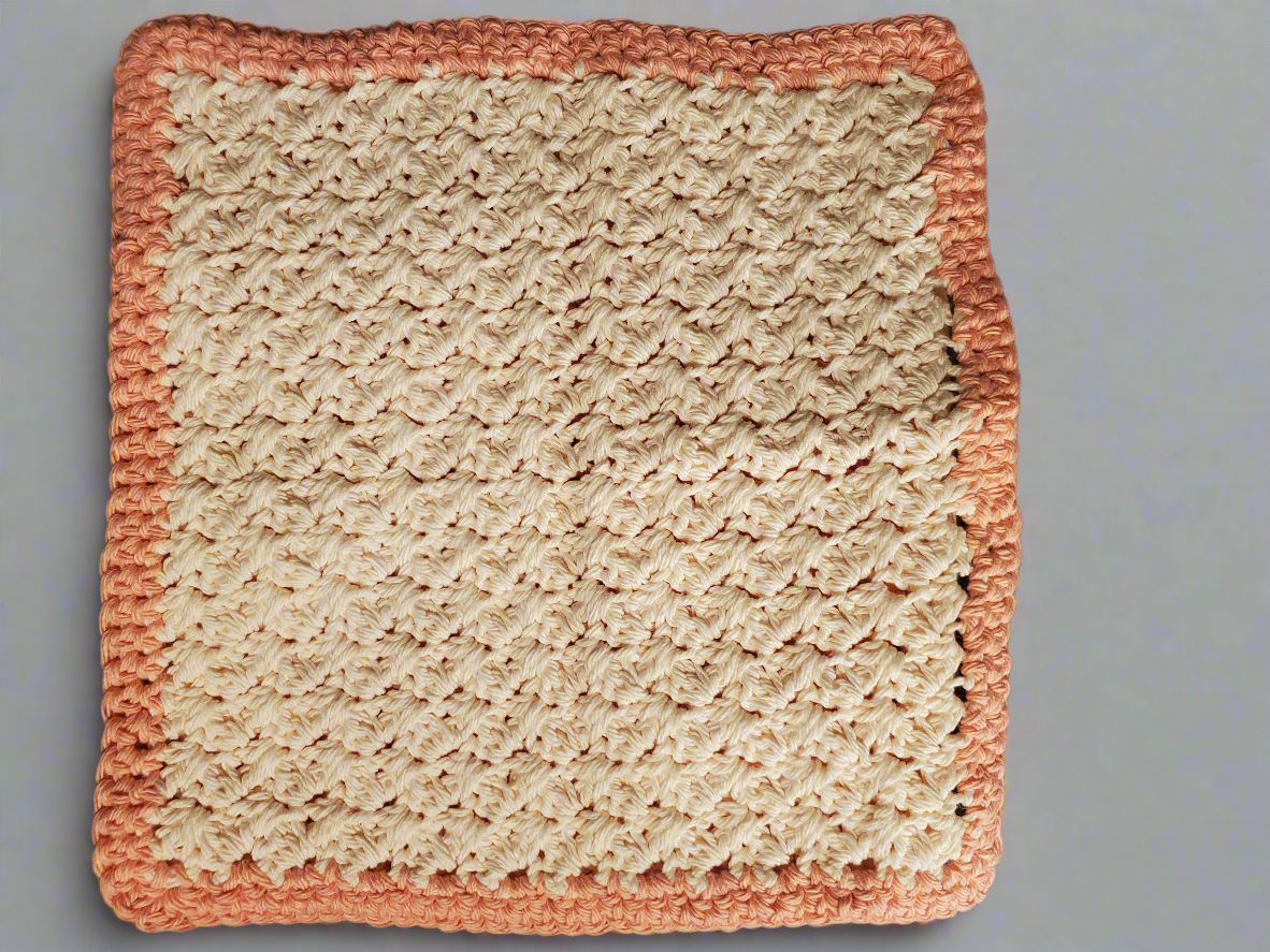 Crocheted cream and tangerine colored dishcloths - set of 4, showcasing intricate stitching and texture for kitchen cleaning.