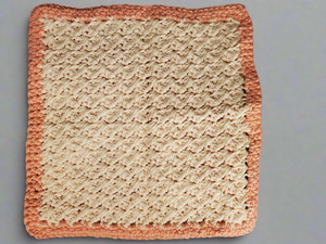 Crocheted cream and tangerine colored dishcloth with intricate stitching, set of 4.