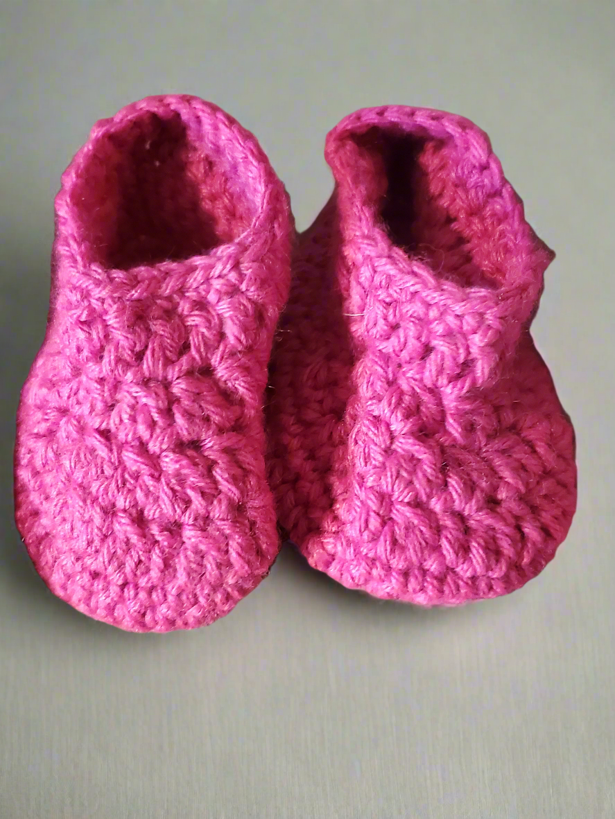 Adorable pink baby hat and booties set, cozy and super-soft.