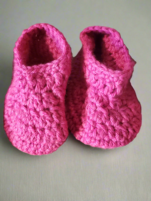 Adorable pink baby hat and booties set, super-soft material, perfect for colder weather.