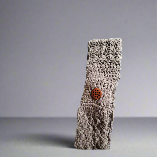 Handmade crocheted headband in gray with button detail for women.