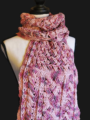 Handmade cotton blend cable scarf in various pinks displayed on mannequin.