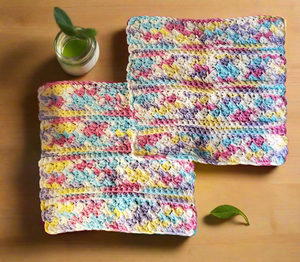 Crocheted cotton rainbow dishcloths set with colorful textured design for cleaning.