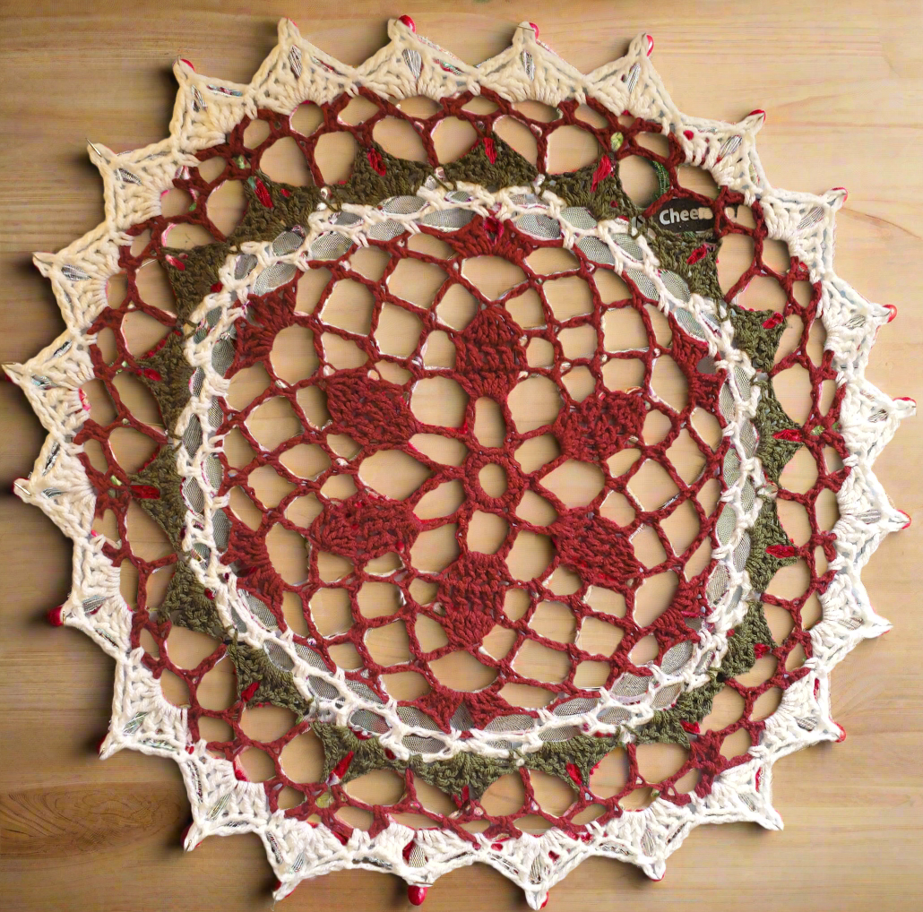 Red, green, and white Christmas doily for festive home decoration.