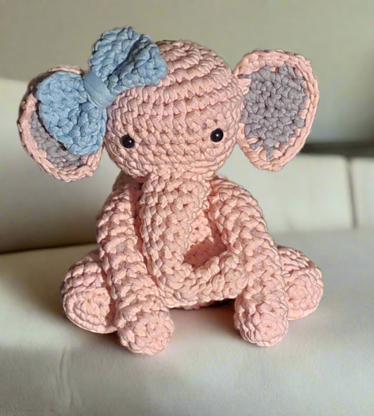 Pink crocheted stuffed elephant doll toy with blue bow