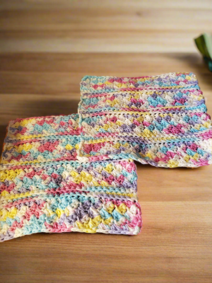 Crocheted cotton rainbow dishcloths set of 4, including 2 regular and 2 large textured for household cleaning.