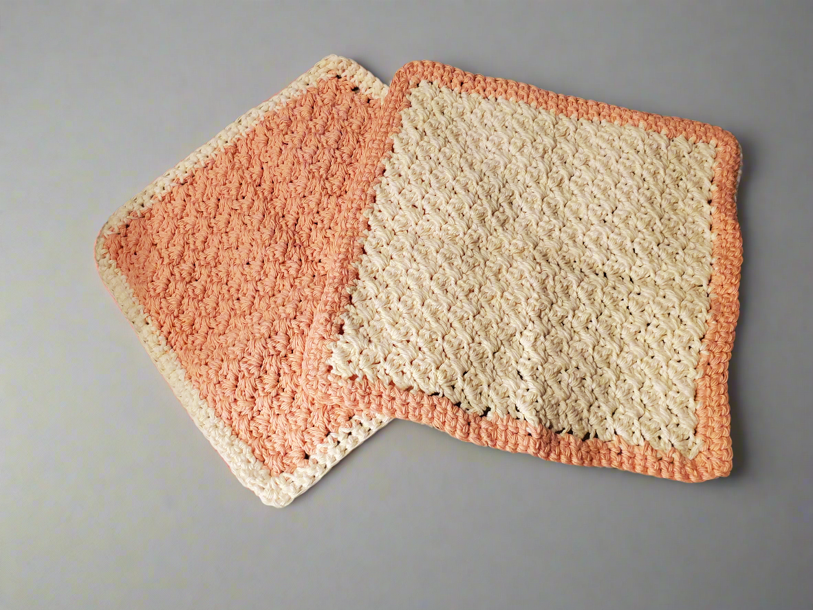 Crocheted cream and tangerine colored dishcloths - set of 4, showcasing intricate stitching and texture for kitchen cleaning.