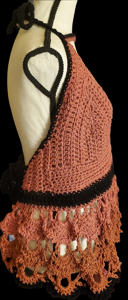 Beautifully handmade crochet bralette in rose and canyon with black accents, featuring an open back and lace hem detail.