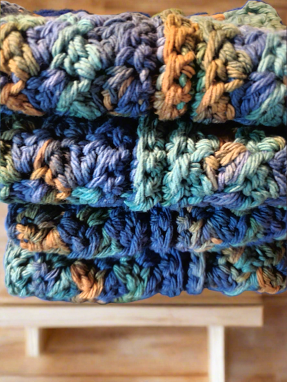 Set of 4 variegated blue, green, and brown dishcloths for washing dishes and cleaning tableware.