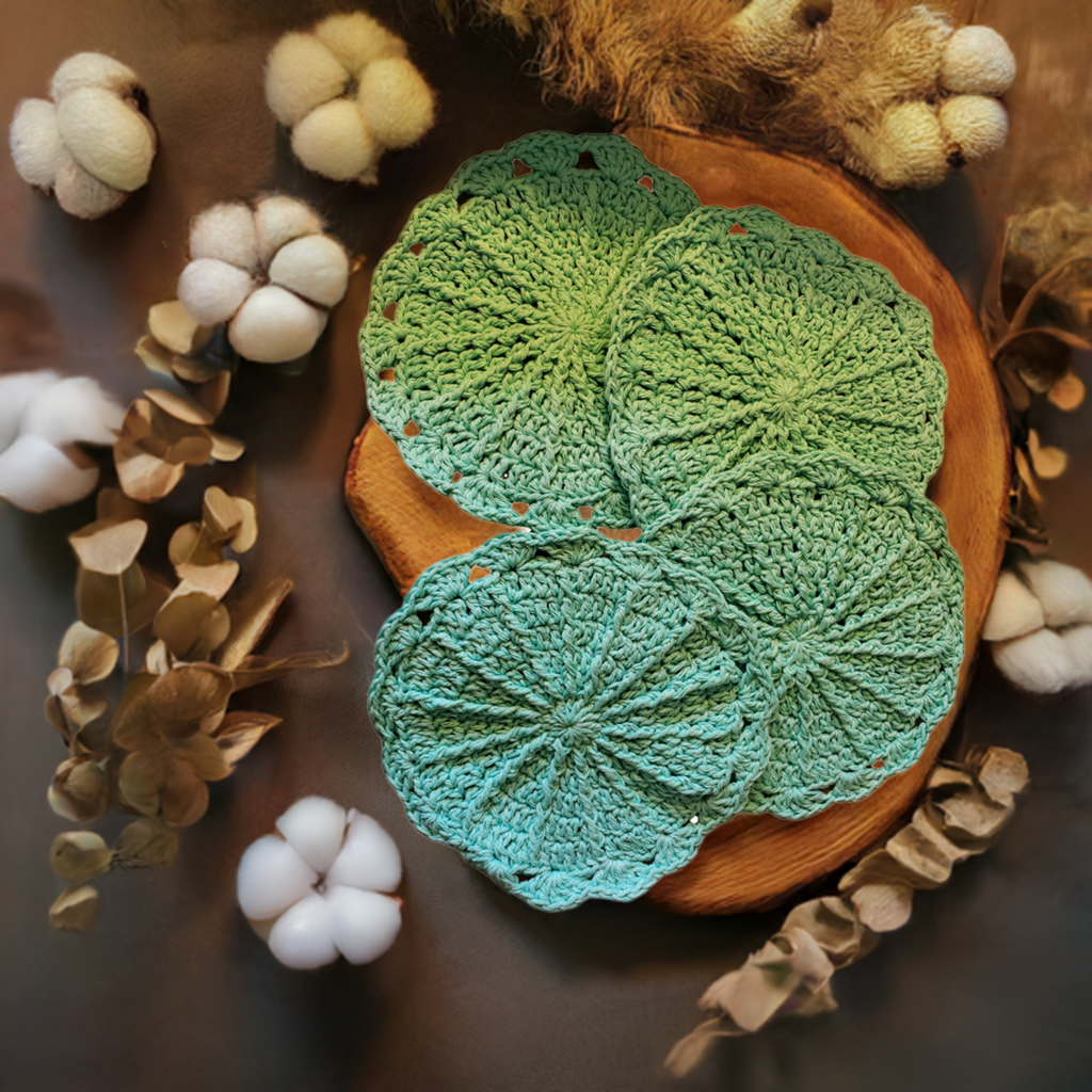 Set of 4 aqua handmade crocheted cotton dishcloths on a rustic wood surface.