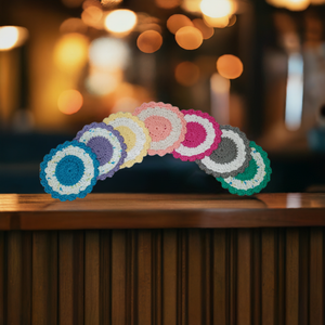 Colorful round cotton coasters set of 4 on a table, showcasing vibrant designs for tableware protection.