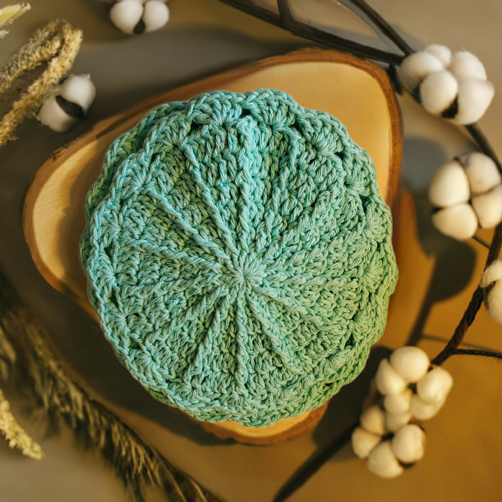 Set of 4 aqua handmade crocheted cotton dishcloths on a rustic wood surface.