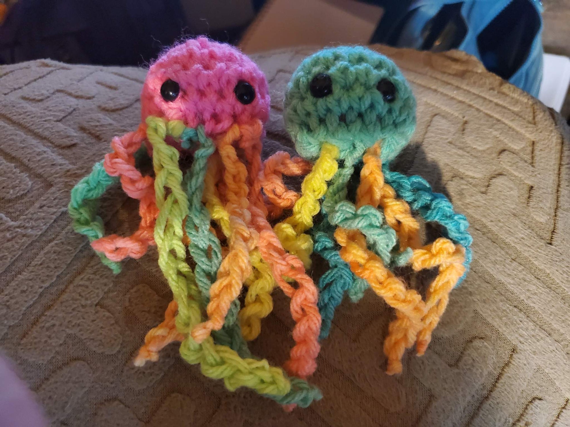 Adorable handmade crocheted baby stuffed jellyfish toy in vibrant colors.