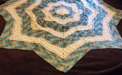 Blue/Gray Camouflage and White Starlight Blanket on bed.