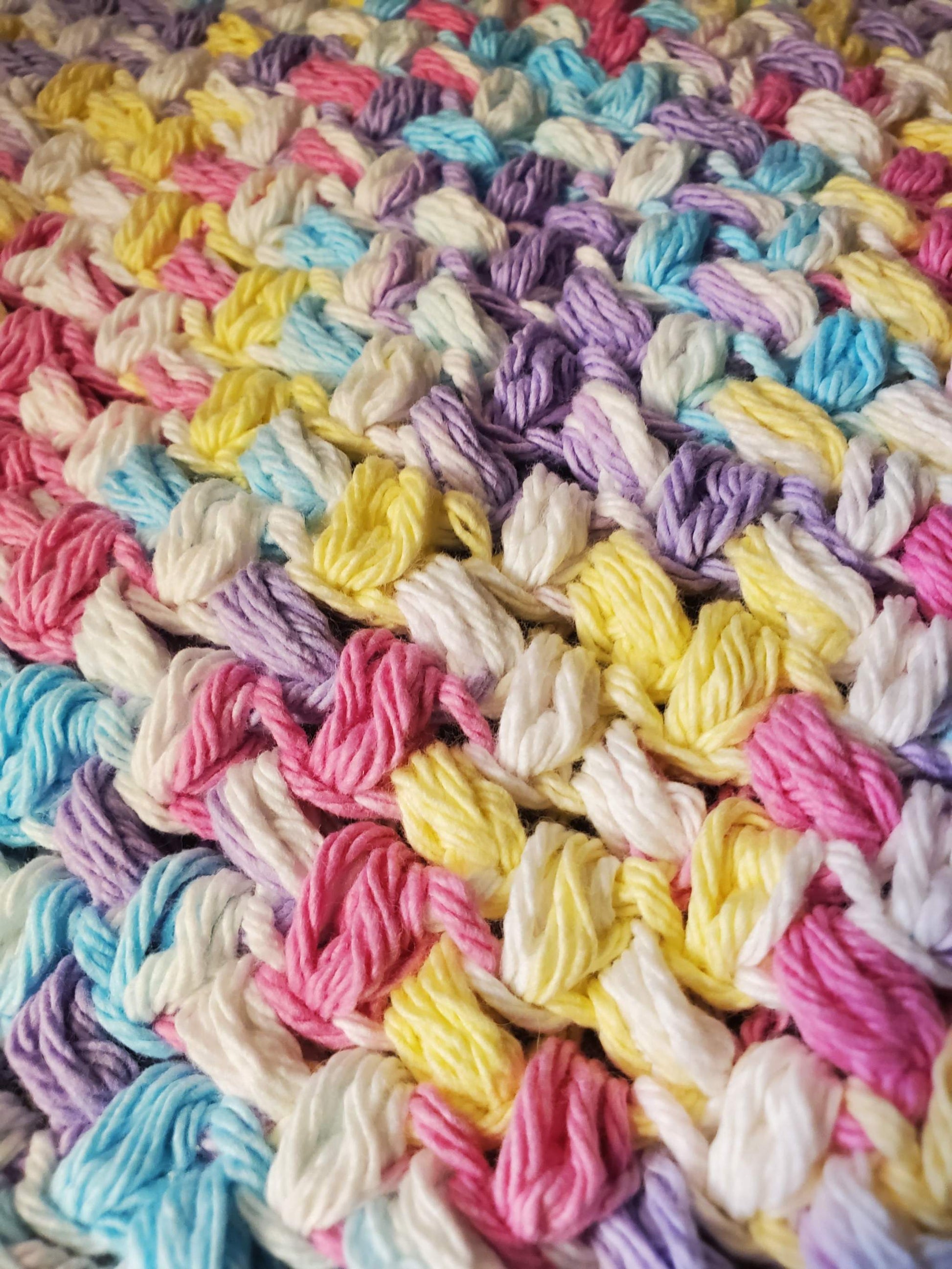 Crocheted rainbow dishcloths set of 4 in cotton, ideal for household cleaning.