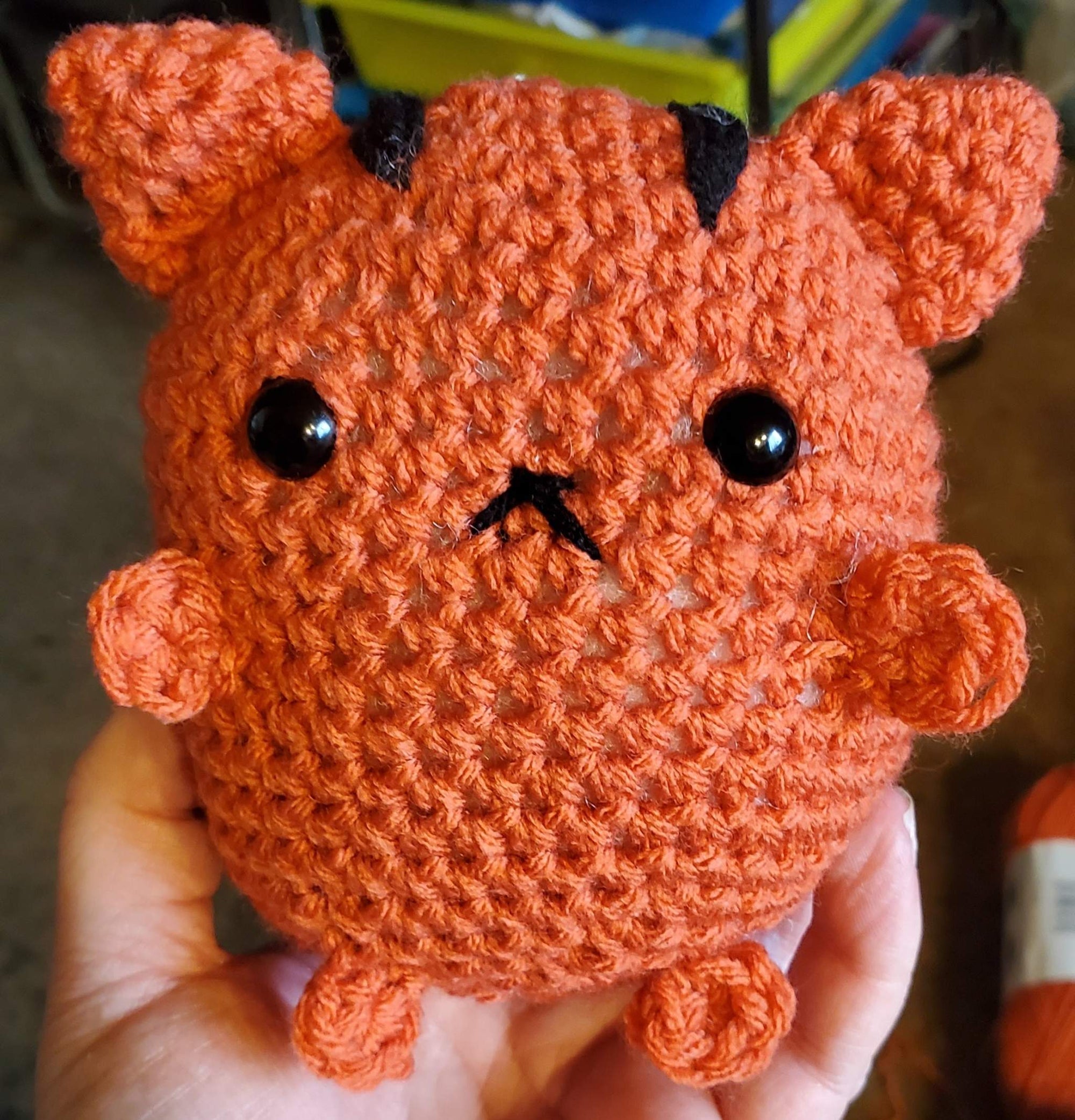 Fat Cat Amigurumi crochet toy with orange yarn and black accents.